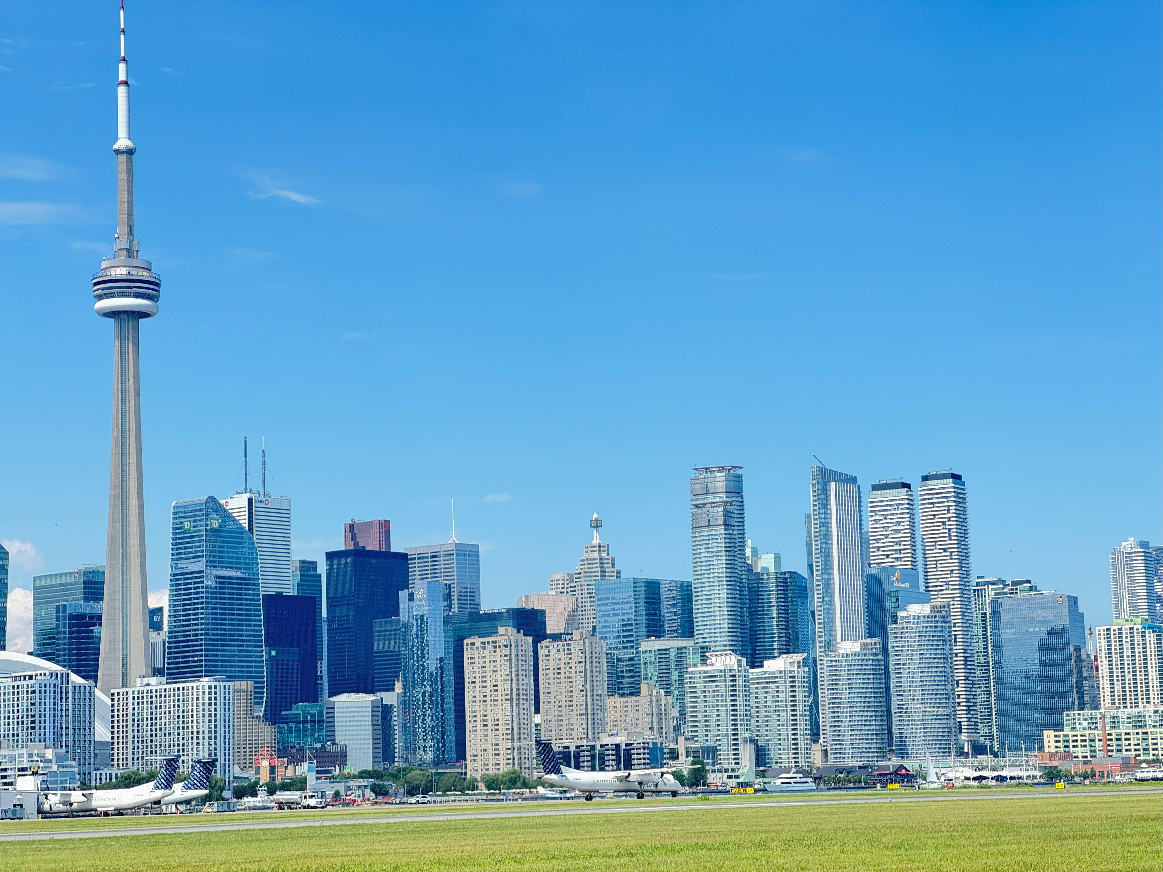 Avion atterrissant à l'aéroport Billy Bishop de Toronto avec la ligne d'horizon de Toronto.